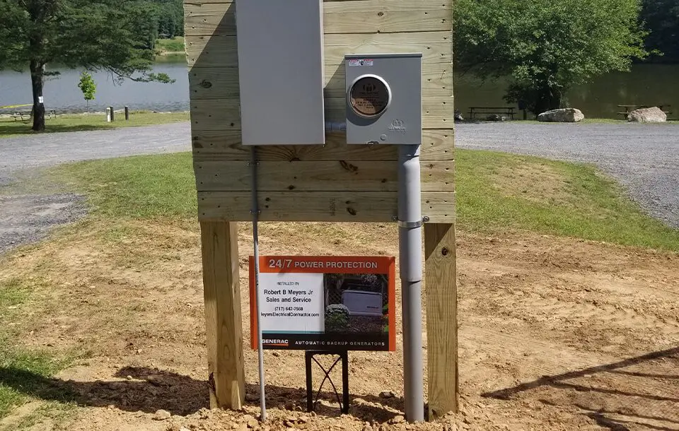 A wooden structure with a sign and a camera.