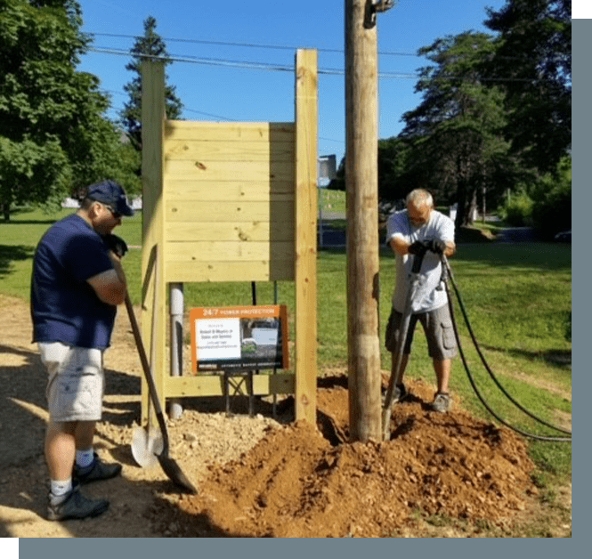 Two men are working on a tree.