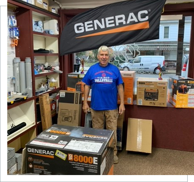 A man standing in front of boxes and other items.