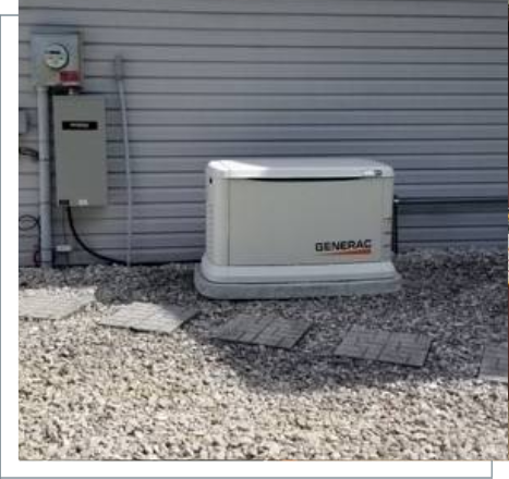 A generator sitting outside of a house on the ground.