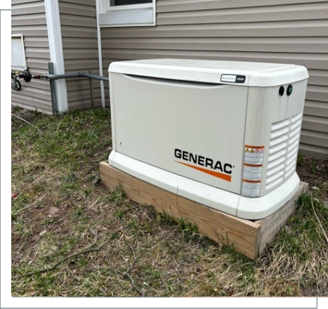 A white generator sitting in the grass outside of a house.