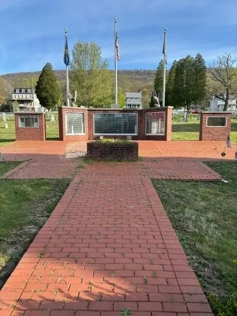 A brick walkway leading to the memorial.